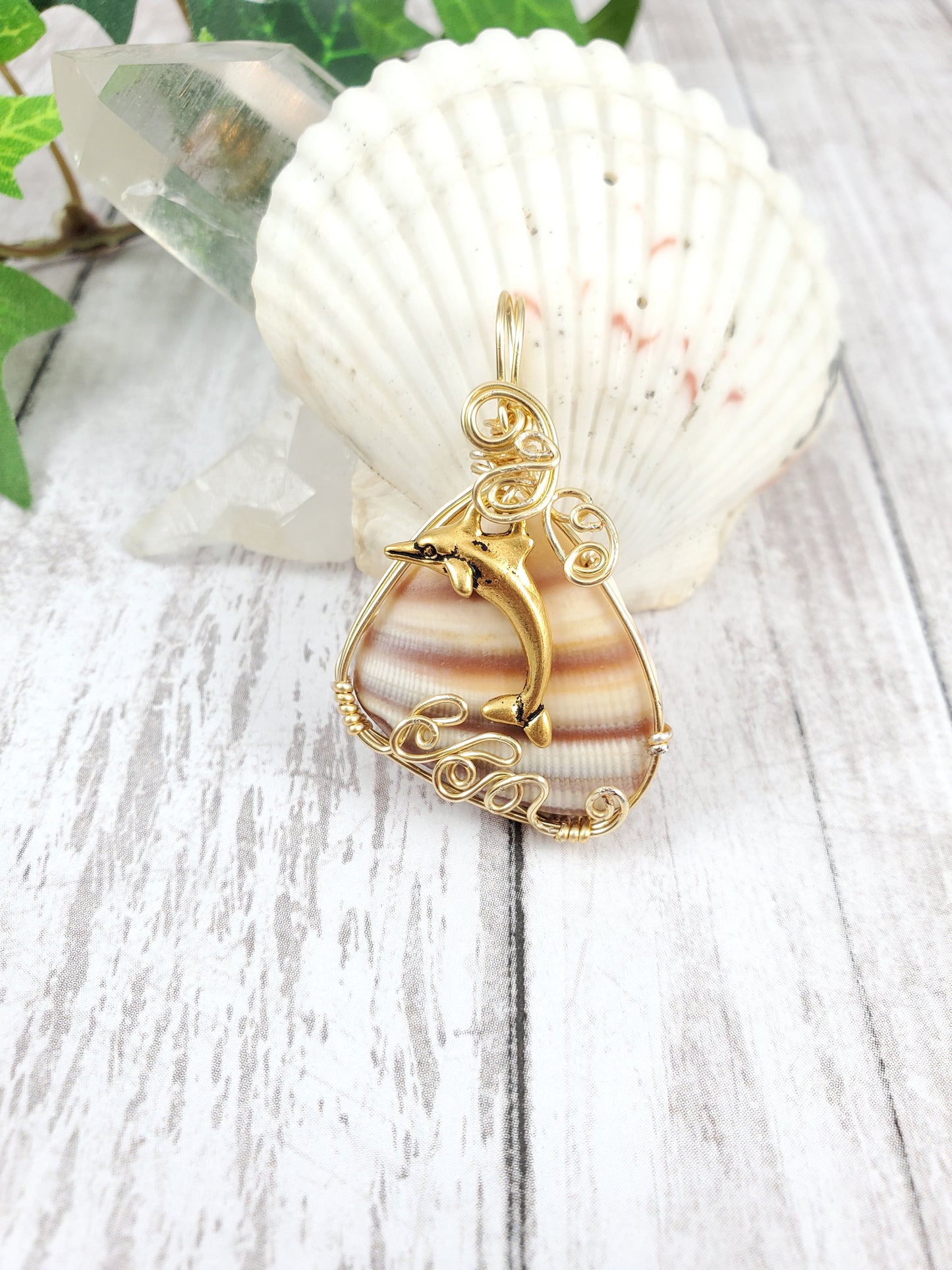 Gold Dolphin Jumping Waves Striped Shell Pendant