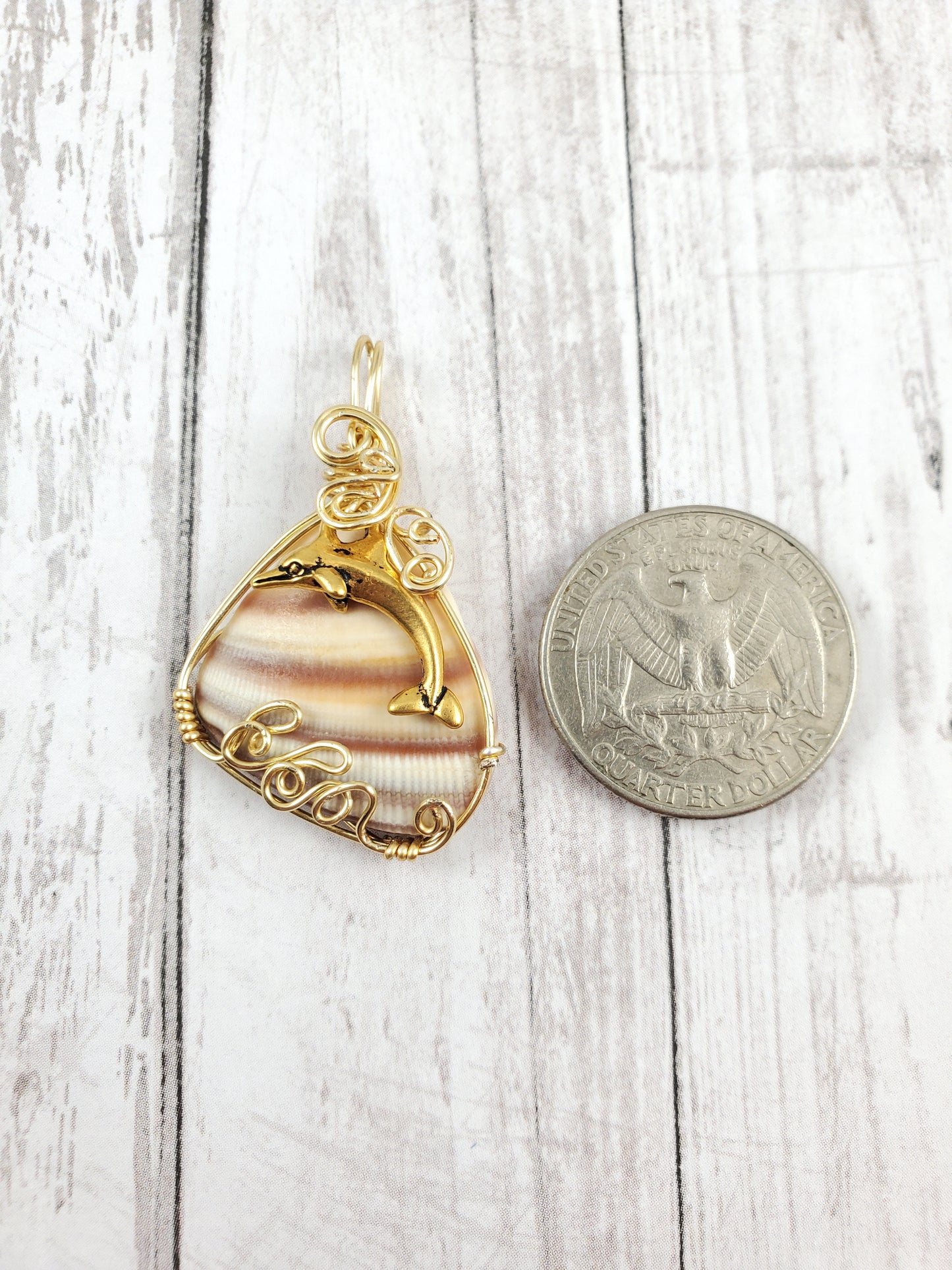 Gold Dolphin Jumping Waves Striped Shell Pendant